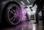 Iron remover chemical reacting purple on a car wheel during decontamination.