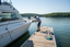Professional boat detailer polishing hull at Lake Anna Virginia dock